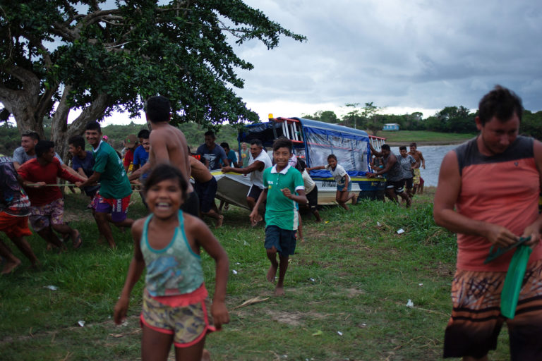 Residents of the Mura Indigenous village of Murutinga, in Brazil’s Amazonas state, take over a boat belonging to employees of the electricity company, who have come to cut off the community's energy supplies. Image by Ana Ionova for Mongabay.