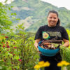 Luz Marina Valle shows off produce after working with the Fundación Entre Mujeres in Nicaragua.