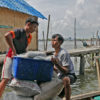 Fishermen haul their catch from the boat.
