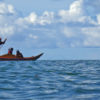Fishermen in a small boat at sea in Koror, Palau.