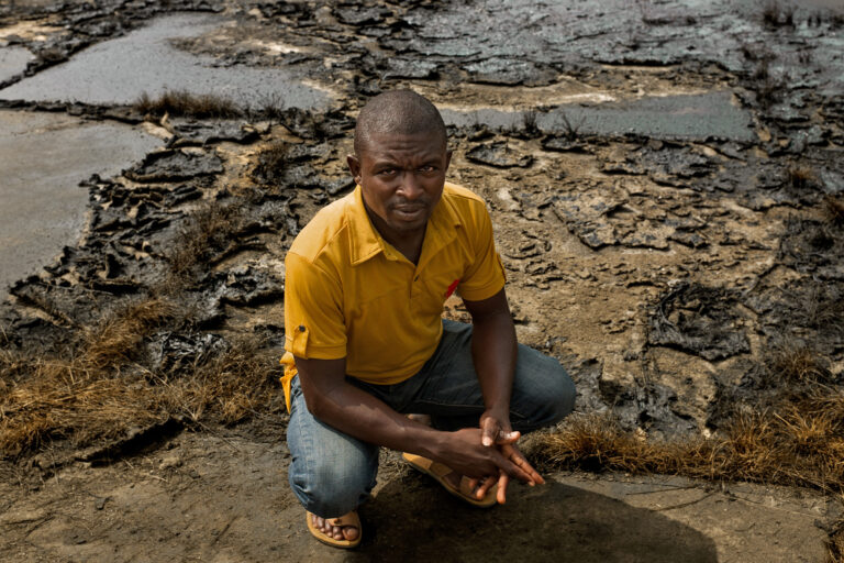 A youth leader demonstrates the impact of oil production on the local community.