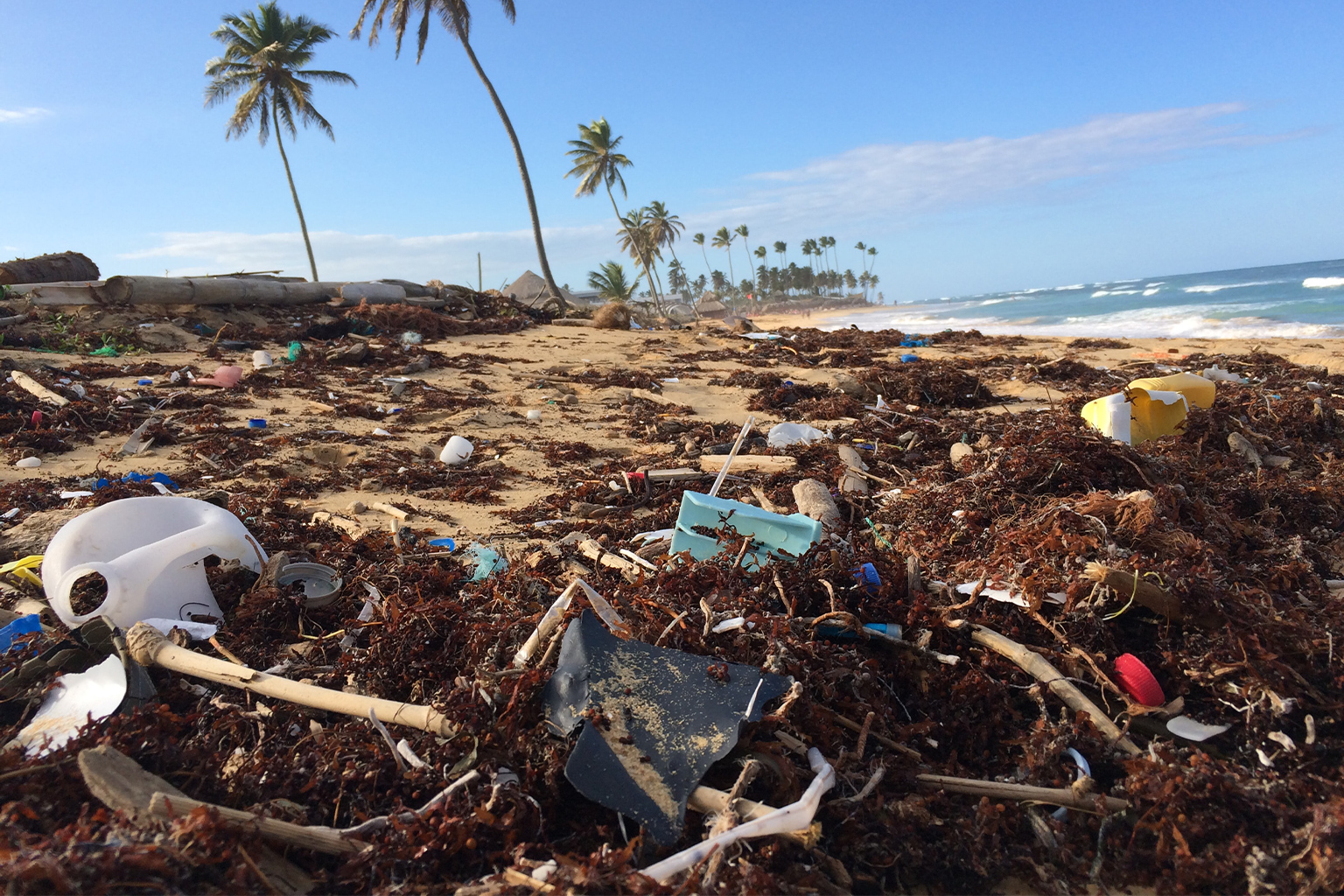 This tropical beach cluttered with plastic debris is only the tip of the global plastics iceberg. 
