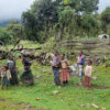 Small children from Rira village stand by the roadside near their humble home.