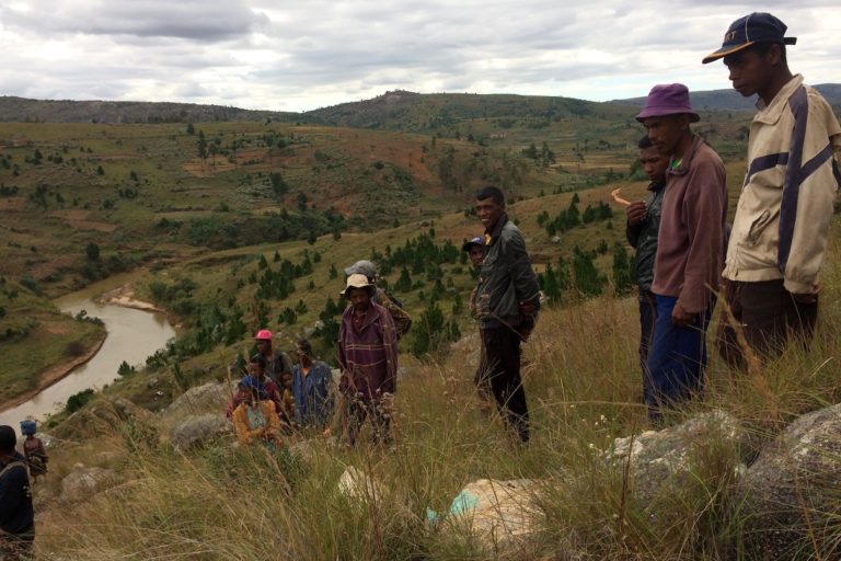Villagers from Farihitsara gather near the proposed dam site. Tozzi Green, the Italian company responsible for the hydroelectric project, marked some of the rocks when it did research at the site. Image by Edward Carver for Mongabay.